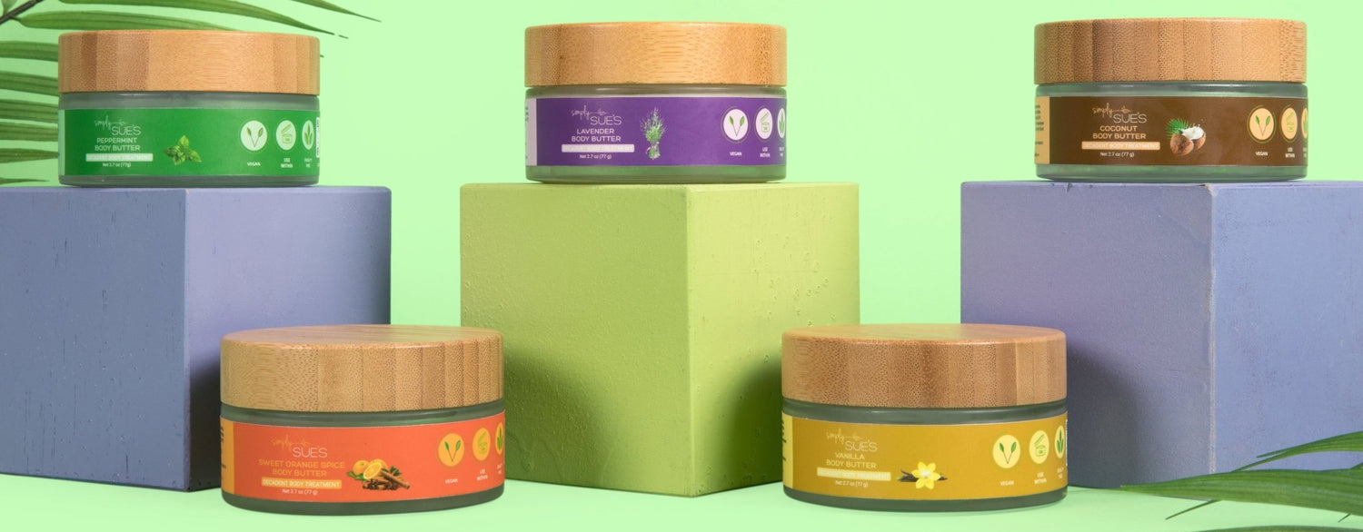 Simply Sue's all natural body butter collection for dry skin on green background and purple and green risers