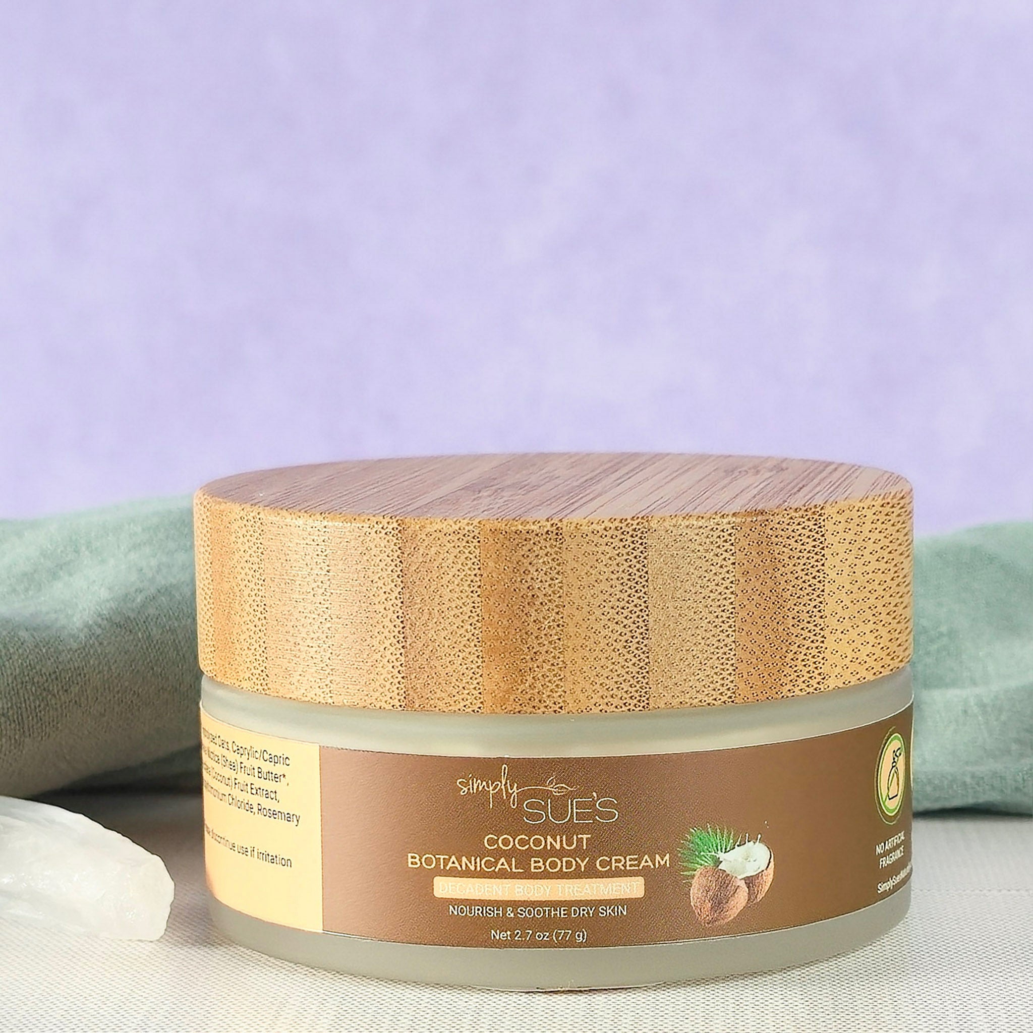 Coconut body cream in glass jar with bamboo cap, natural moisturizing skincare