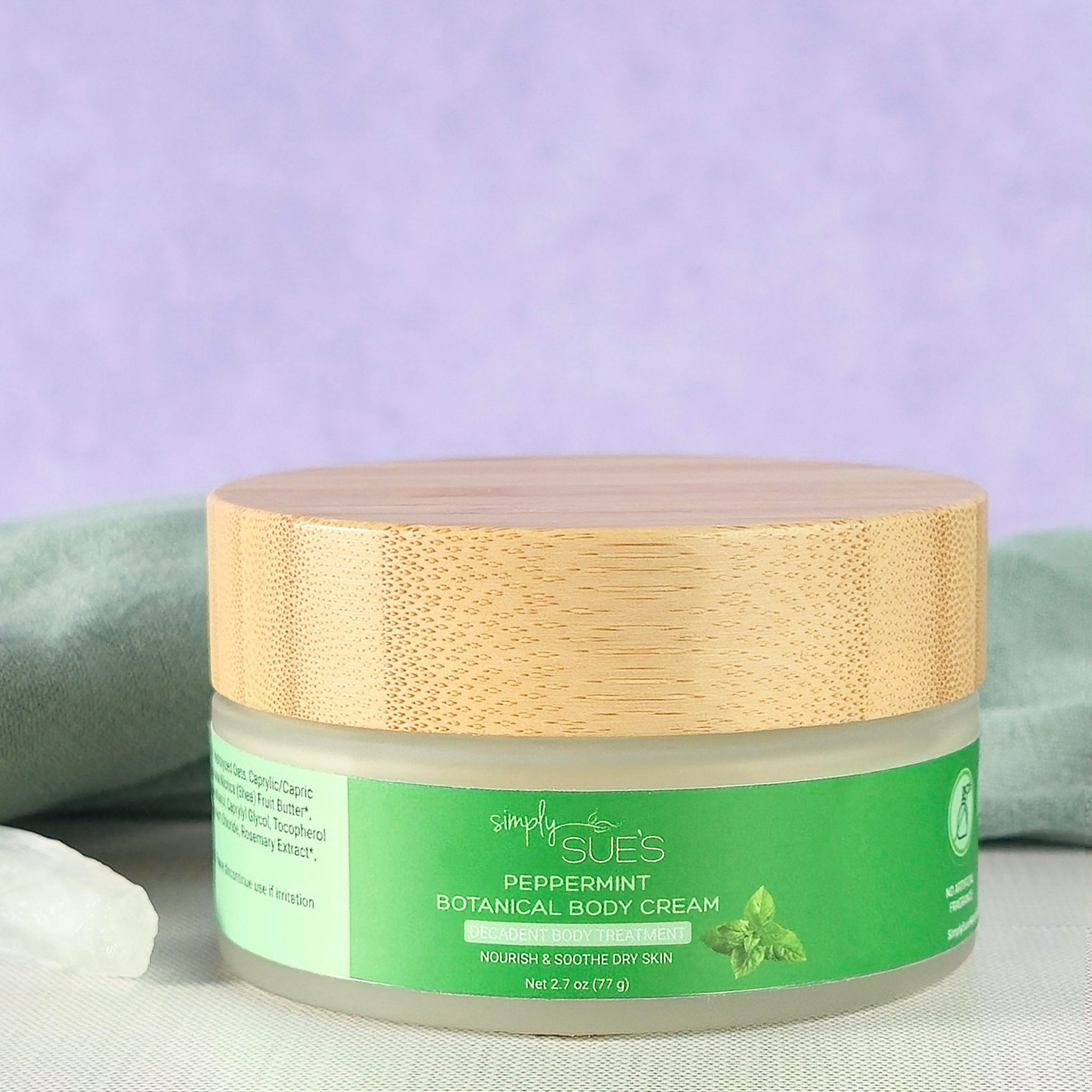 Peppermint body cream in glass jar with bamboo cap, natural moisturizing skincare