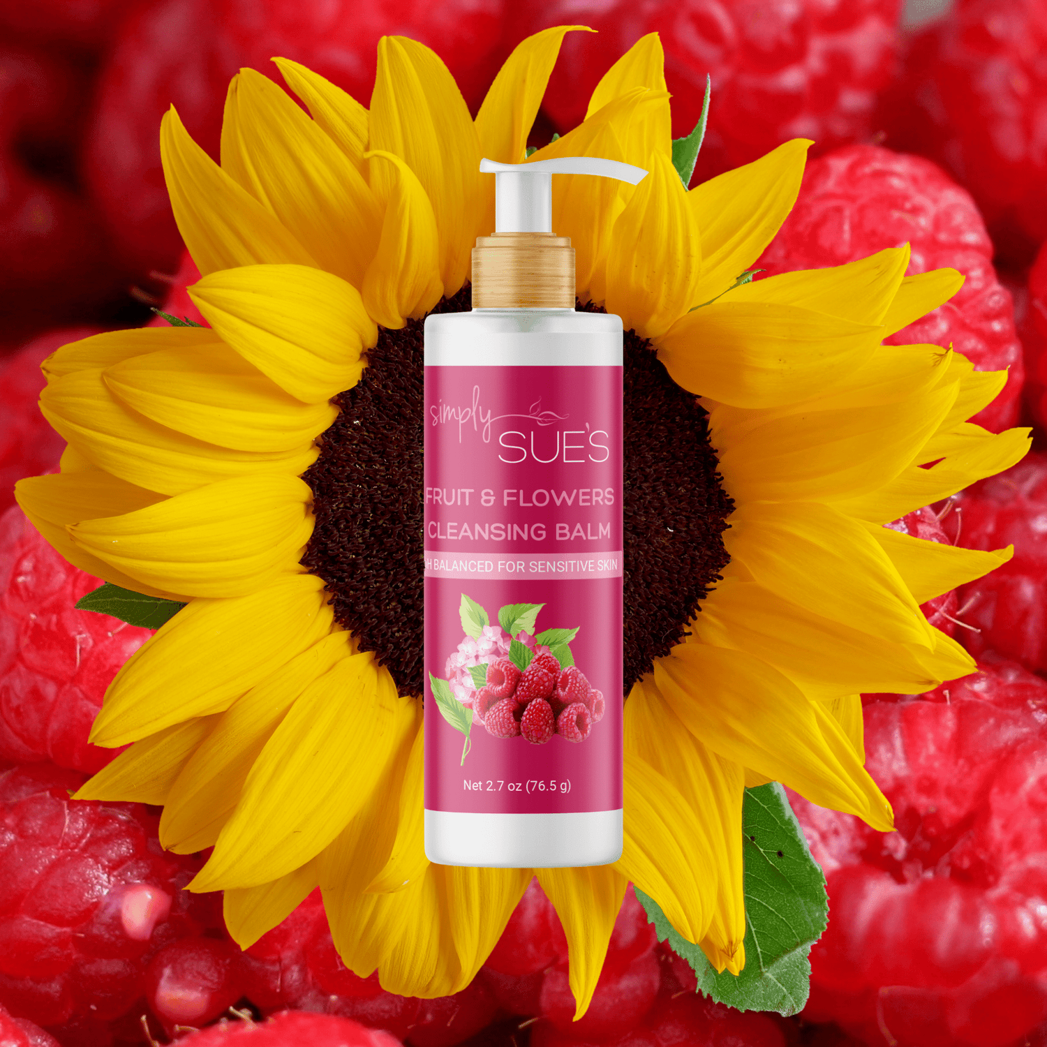 Fruit & Flowers Cleansing Balm in a glass bottle with bamboo pump and on a background of raspberries and a sunflower