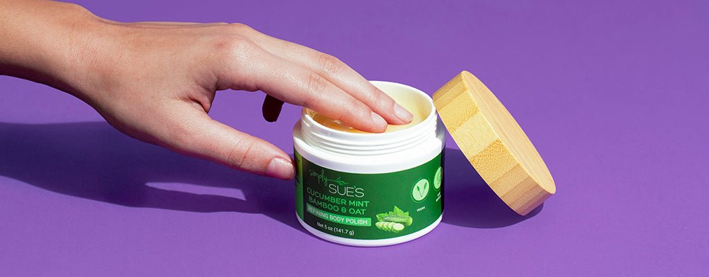 woman putting hand in Simply Sue's All natural Cucumber Mint Refining Body Polish on purple background