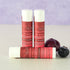 Cherry Berry lip balm for dry lips by Simply Sue’s with natural ingredients, styled with cherries and blueberries.