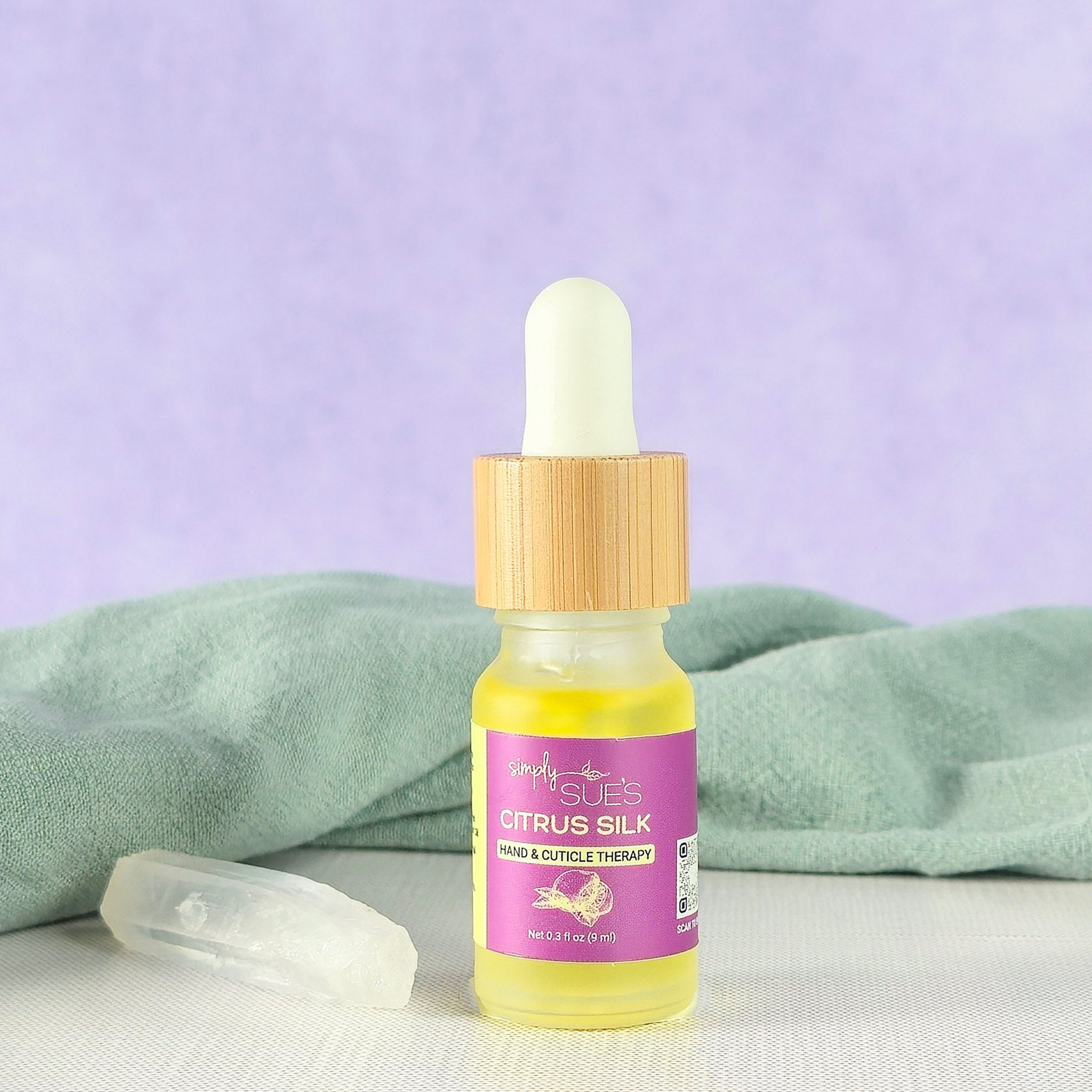 Cuticle oil in a glass bottle with bamboo cap, nourishing hand and nail care that softens and restores cuticles