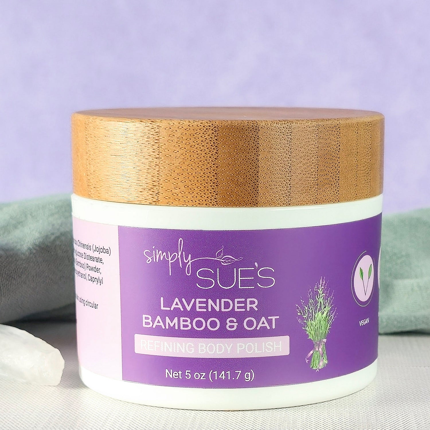 Lavender body polish, exfoliating sugar scrub that smooths dry skin, in a white jar with bamboo lid
