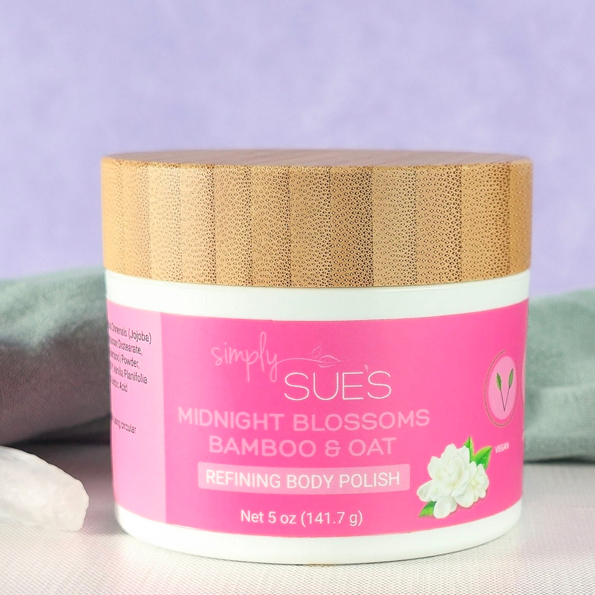 Midnight Blossom body polish, exfoliating sugar scrub that smooths dry skin, in a white jar with bamboo lid
