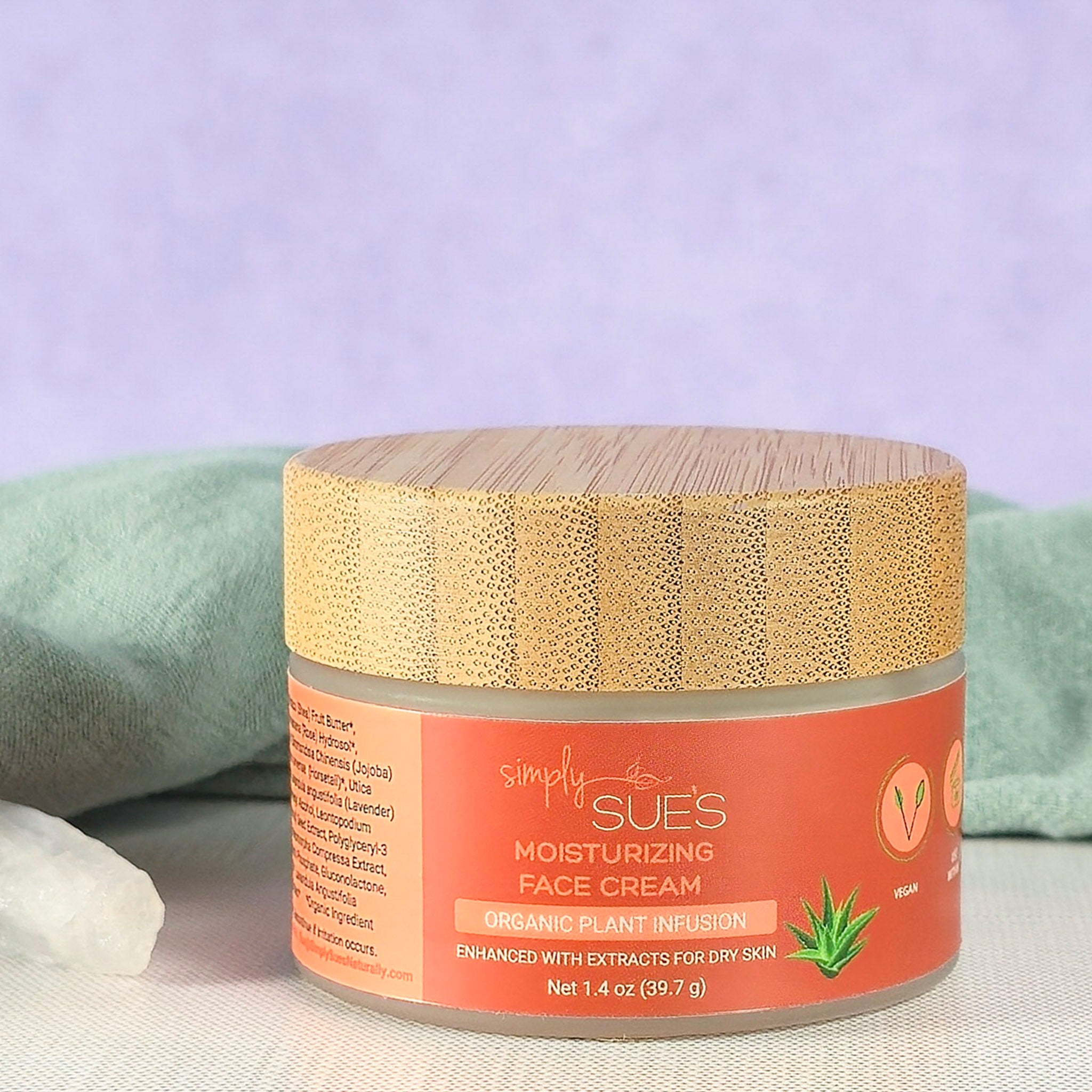 Natural vegan face cream in a glass jar with bamboo cap on a soft purple background, hydrating and softening skin