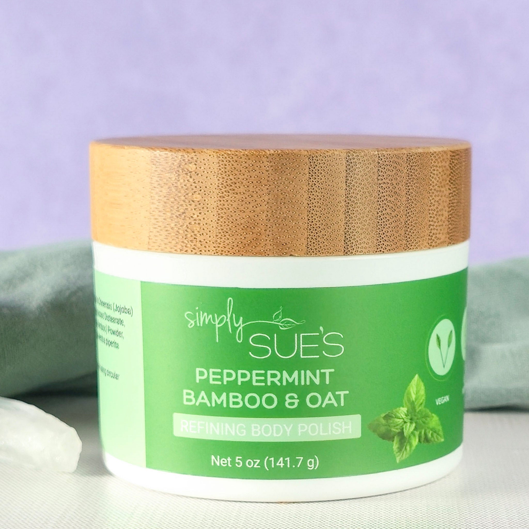 Peppermint body polish, exfoliating sugar scrub that smooths dry skin, in a white jar with bamboo lid