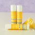 Pina colada lip balm tubes by Simply Sue’s with coconut and pineapple on a neutral background