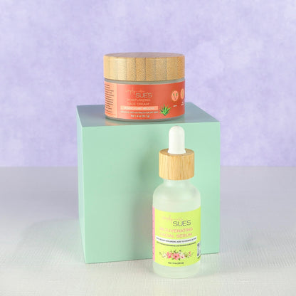 Natural skincare set with facial serum and face cream in glass bottles and jars with bamboo lids on soft purple background