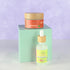 Natural skincare set with facial serum and face cream in glass bottles and jars with bamboo lids on soft purple background