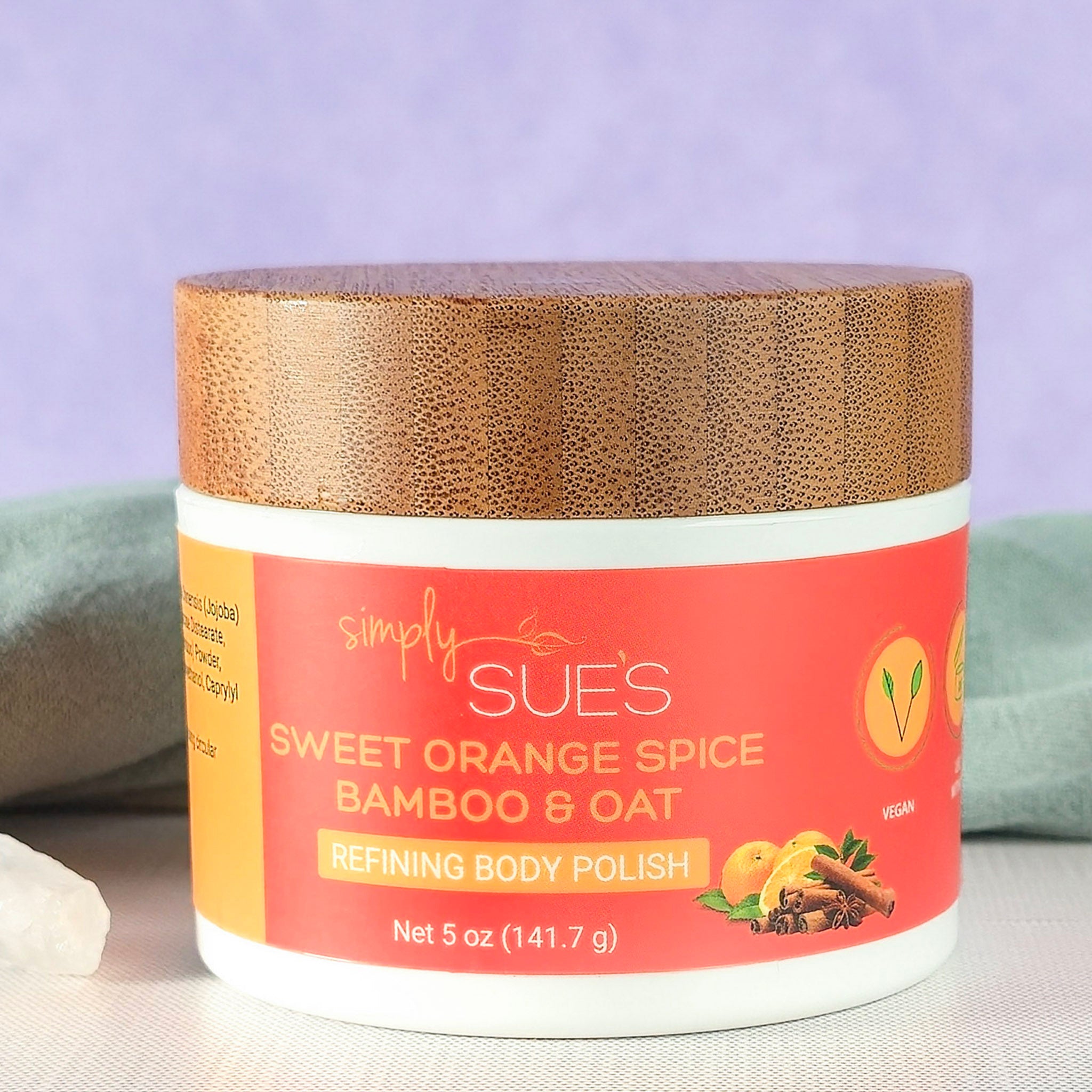 sweet orange spice body polish, exfoliating sugar scrub that smooths dry skin, in a white jar with bamboo lid