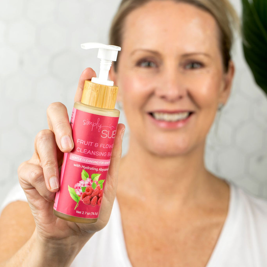 A close up of a Woman holding Fruit & Flowers Cleansing Balm